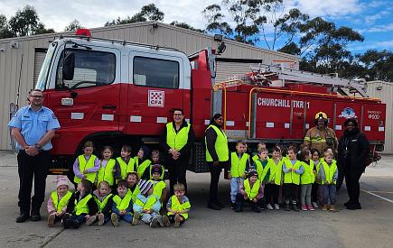 Children, teachers and CFA members in front of CFA truck