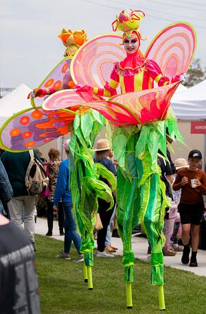 Stilt walkers in flower costumes