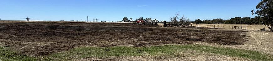 Extensive area of grass blackened by fire