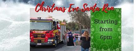child greeting santa in fire truck