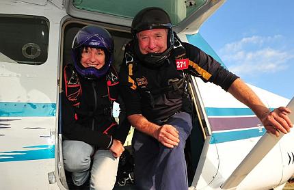 Janine and Ken posed in doorway of plane